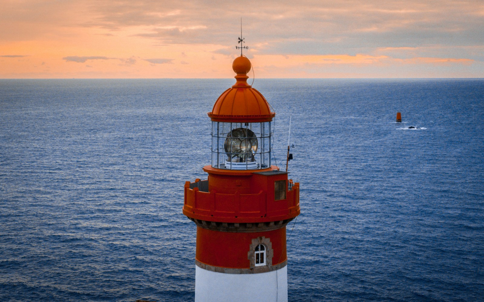 Photo by Pierre Becam red and white lighthouse on the sea during daytime
